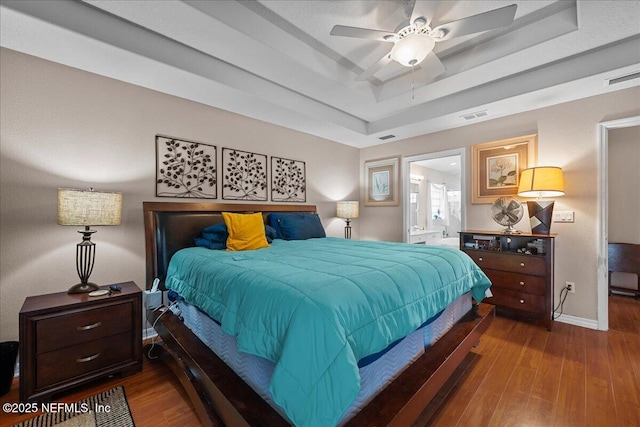 45 E Diamond Dr, Palm Coast, FL 32164 - bedroom with a raised ceiling, wood finished floors, and ensuite bath