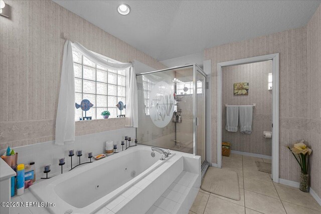 45 E Diamond Dr, Palm Coast, FL 32164 - bathroom with a stall shower, a jetted tub, tile patterned floors, wallpapered walls, and a textured ceiling