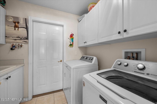 45 E Diamond Dr, Palm Coast, FL 32164 - laundry room featuring washer and clothes dryer, cabinet space, and light tile patterned floors