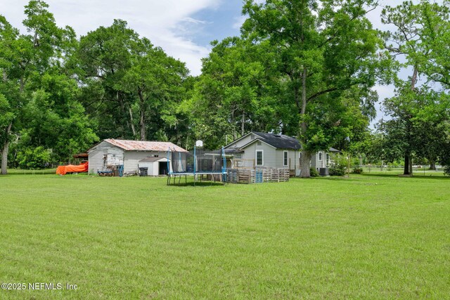 85215 Airplane Ln, Yulee, FL 32097 - view of grassy yard featuring a trampoline and a shed
