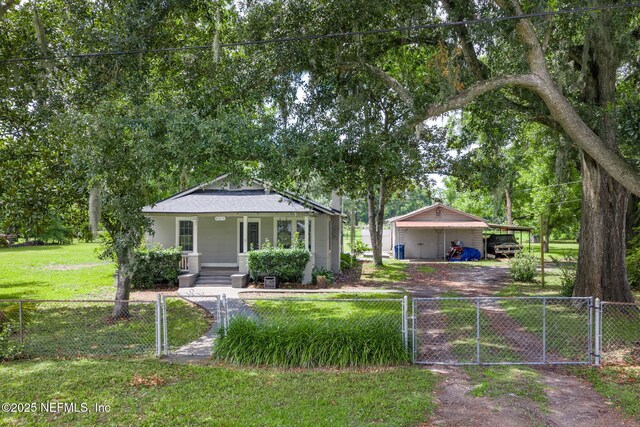 85215 Airplane Ln, Yulee, FL 32097 - bungalow with covered porch, a gate, a fenced front yard, and roof with shingles