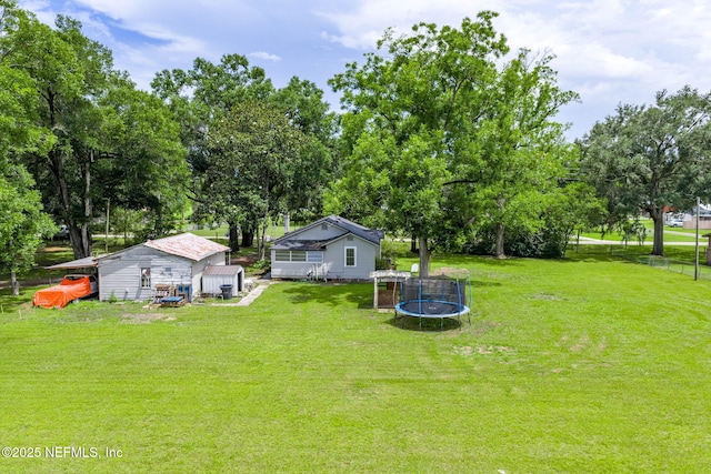 85215 Airplane Ln, Yulee, FL 32097 - view of yard featuring a trampoline and view of wooded area