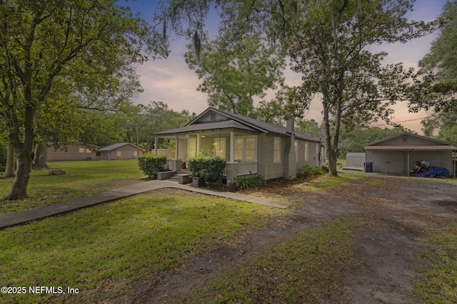 85215 Airplane Ln, Yulee, FL 32097 - view of front of house featuring a yard, a chimney, covered porch, a carport, and dirt driveway