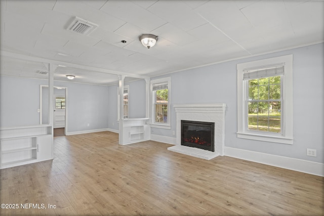 85215 Airplane Ln, Yulee, FL 32097 - unfurnished living room with plenty of natural light, wood finished floors, and a brick fireplace