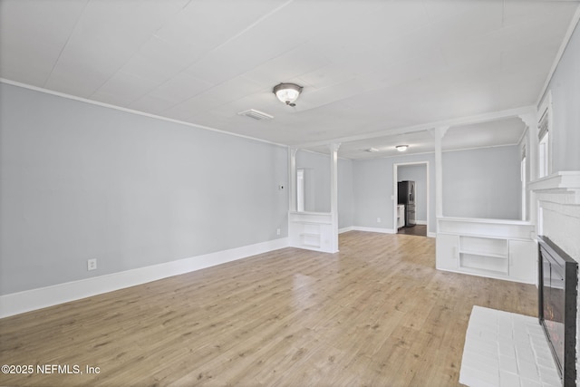 85215 Airplane Ln, Yulee, FL 32097 - unfurnished living room with a brick fireplace, wood finished floors, and crown molding