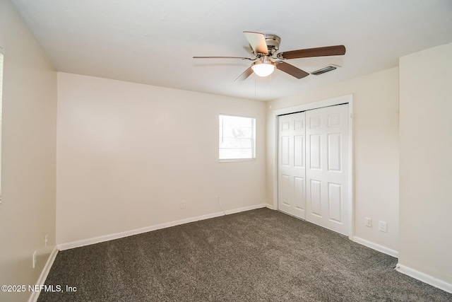 2415 Mill Creek Rd, Jacksonville, FL 32211 - unfurnished bedroom with dark colored carpet, a closet, and ceiling fan