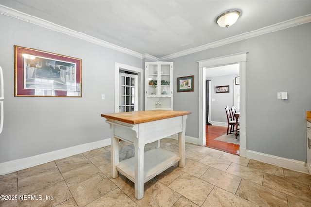 22 Marion St, Saint Augustine, FL 32084 - kitchen with wooden counters, open shelves, crown molding, white cabinets, and glass insert cabinets