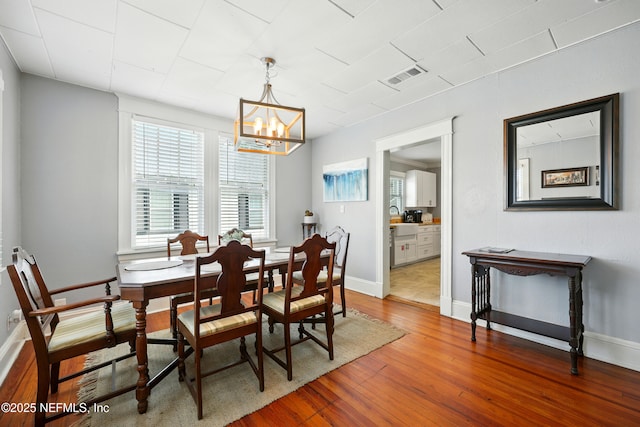 22 Marion St, Saint Augustine, FL 32084 - dining room featuring wood finished floors and a chandelier