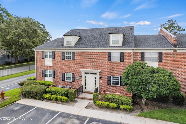4915 Baymeadows Rd Unit 8B, Jacksonville, FL 32217 - view of front of home with uncovered parking, brick siding, and a shingled roof