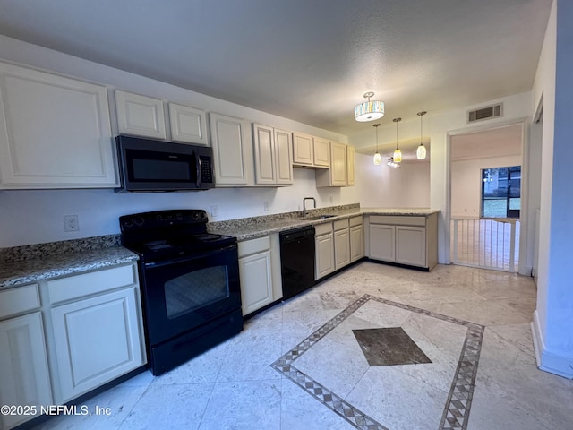8880 Old Kings Rd S Unit 53, Jacksonville, FL 32257 - kitchen with black appliances, inlaid floor details, and pendant lighting