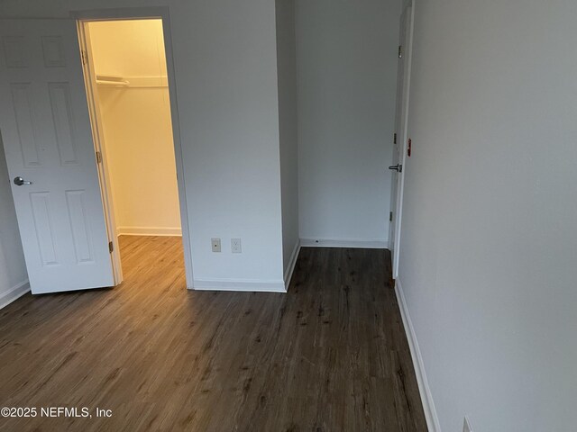 8880 Old Kings Rd S Unit 53, Jacksonville, FL 32257 - unfurnished bedroom with a walk in closet, wood finished floors, and a closet