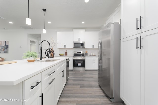1114 Nantucket Ave, Jacksonville, FL 32233 - kitchen with appliances with stainless steel finishes, wood finished floors, white cabinetry, recessed lighting, and pendant lighting