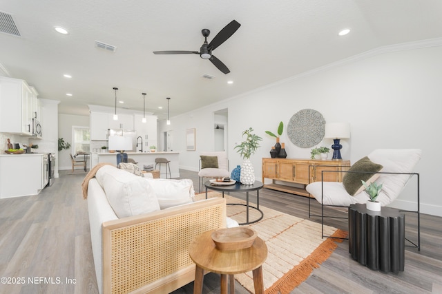 1114 Nantucket Ave, Jacksonville, FL 32233 - living area featuring ornamental molding, light wood-style flooring, a ceiling fan, and recessed lighting