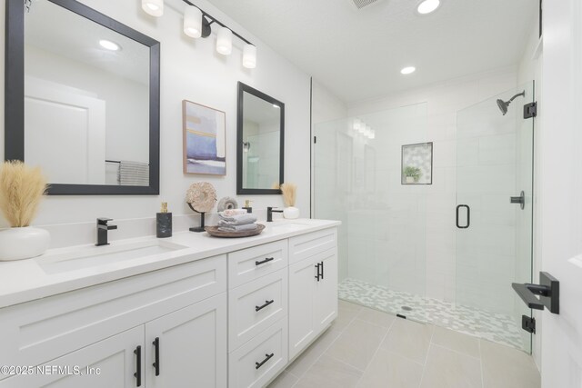 1114 Nantucket Ave, Jacksonville, FL 32233 - bathroom featuring double vanity, a stall shower, tile patterned flooring, and recessed lighting