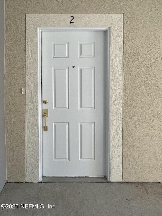 5151 Playpen Dr Unit 7-2, Jacksonville, FL 32210 - doorway to property with stucco siding