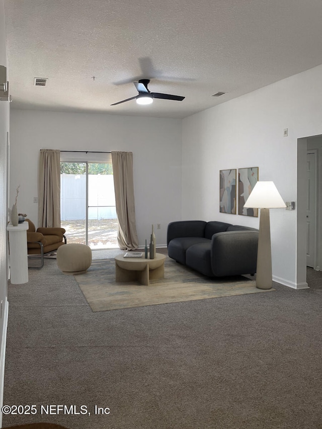5151 Playpen Dr Unit 7-2, Jacksonville, FL 32210 - carpeted living room featuring a textured ceiling and a ceiling fan
