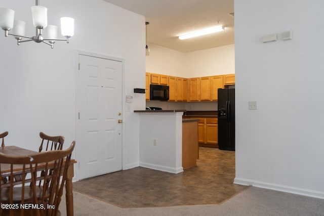 5151 Playpen Dr Unit 7-2, Jacksonville, FL 32210 - kitchen featuring black appliances, a chandelier, dark countertops, and hanging light fixtures