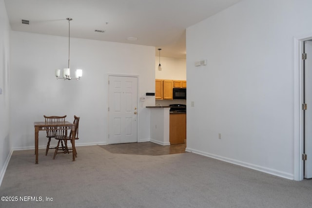 5151 Playpen Dr Unit 7-2, Jacksonville, FL 32210 - kitchen with carpet flooring, black microwave, a chandelier, hanging light fixtures, and stove