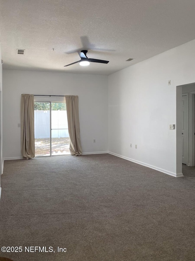 5151 Playpen Dr Unit 7-2, Jacksonville, FL 32210 - empty room with a ceiling fan, dark colored carpet, and a textured ceiling