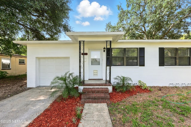 6552 Shady Oak Dr, Jacksonville, FL 32277 - view of front facade with concrete driveway and a garage