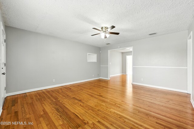 6552 Shady Oak Dr, Jacksonville, FL 32277 - empty room featuring a ceiling fan, light wood-type flooring, and a textured ceiling