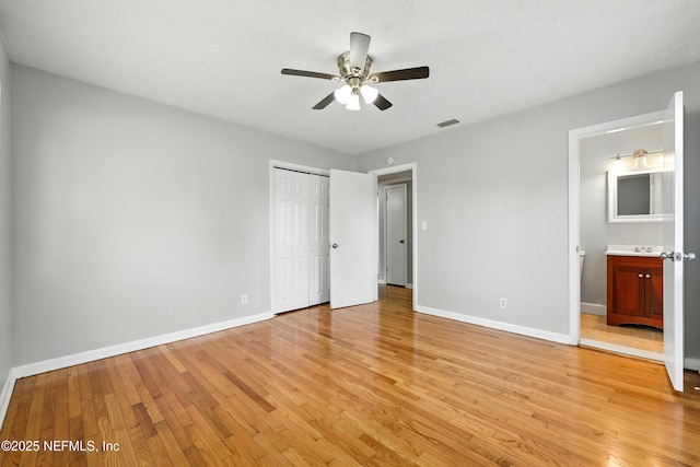 6552 Shady Oak Dr, Jacksonville, FL 32277 - unfurnished bedroom with light wood-style floors, a closet, ensuite bathroom, and a ceiling fan