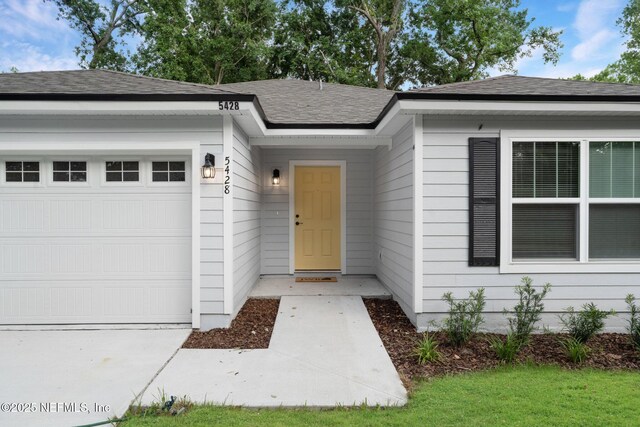 5428 Chenango Blvd, Jacksonville, FL 32254 - view of exterior entry featuring a garage and roof with shingles