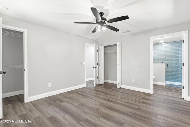 110 Pleasant Dr, East Palatka, FL 32131 - unfurnished bedroom with wood finished floors, connected bathroom, and a ceiling fan