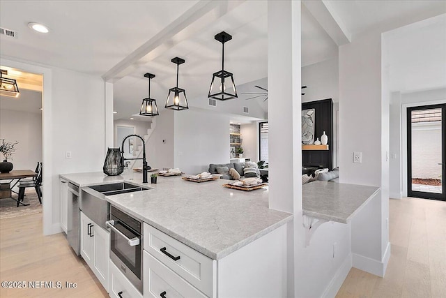 172 Laurel Ln, Ponte Vedra Beach, FL 32082 - kitchen featuring white cabinetry, light wood-type flooring, pendant lighting, stainless steel dishwasher, and recessed lighting