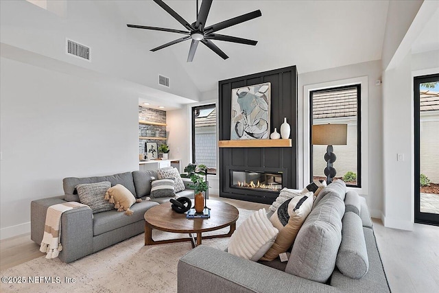 172 Laurel Ln, Ponte Vedra Beach, FL 32082 - living room featuring light wood-style flooring, a ceiling fan, a fireplace, and high vaulted ceiling