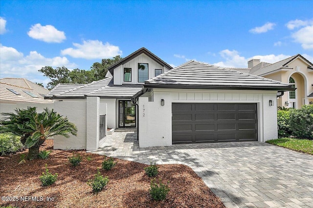 172 Laurel Ln, Ponte Vedra Beach, FL 32082 - modern farmhouse featuring a garage, decorative driveway, a tiled roof, and brick siding