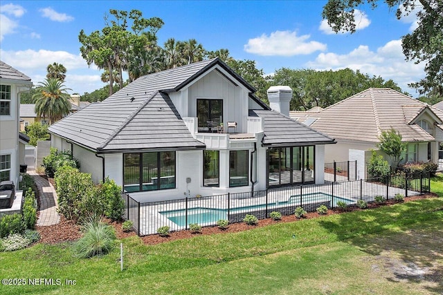 172 Laurel Ln, Ponte Vedra Beach, FL 32082 - rear view of house with a chimney, a fenced backyard, a balcony, a patio area, and a tiled roof