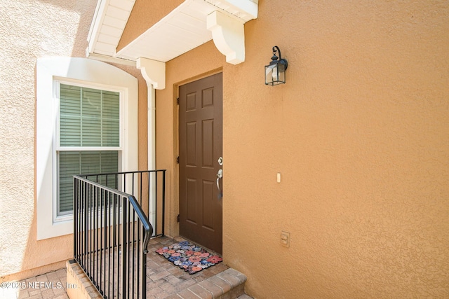 11890 Surfbird Cir Unit 42E, Jacksonville, FL 32256 - doorway to property with stucco siding