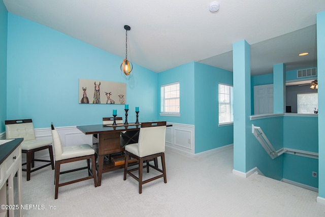 11890 Surfbird Cir Unit 42E, Jacksonville, FL 32256 - dining space with light colored carpet, wainscoting, and lofted ceiling