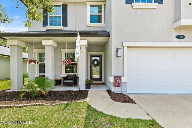 190 Colorado Springs Way, Saint Augustine, FL 32092 - doorway to property with a porch, stucco siding, a garage, and concrete driveway