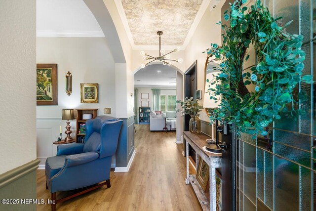 190 Colorado Springs Way, Saint Augustine, FL 32092 - entrance foyer featuring ornamental molding, arched walkways, light wood finished floors, and a chandelier