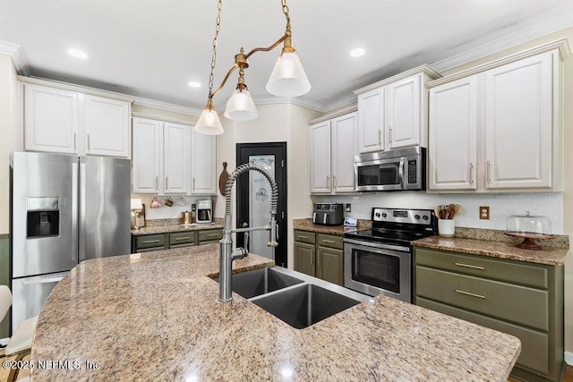 190 Colorado Springs Way, Saint Augustine, FL 32092 - kitchen with stainless steel appliances, crown molding, hanging light fixtures, white cabinetry, and light stone countertops