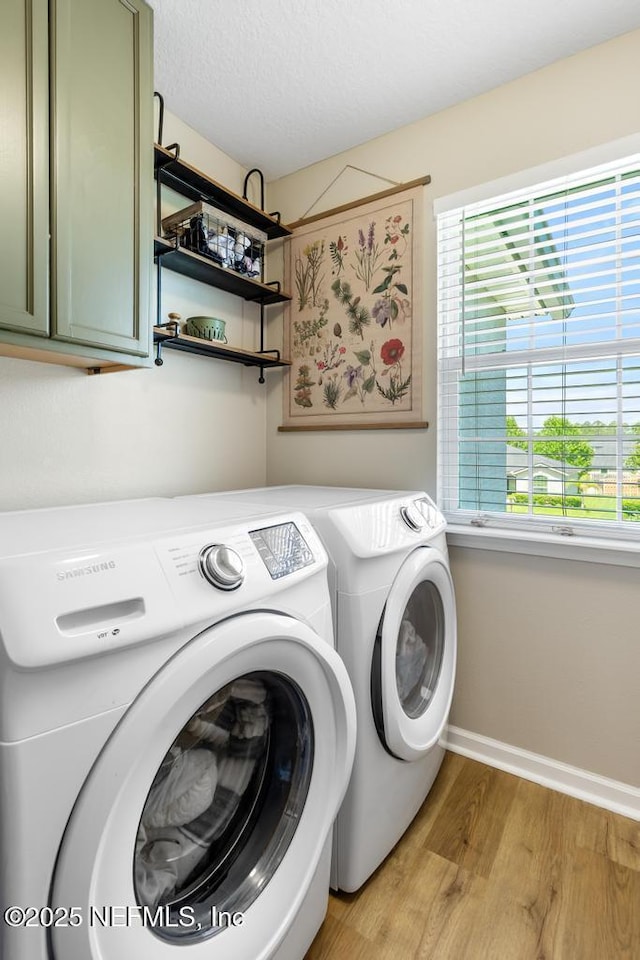 190 Colorado Springs Way, Saint Augustine, FL 32092 - laundry area with cabinet space, washer and dryer, and light wood finished floors