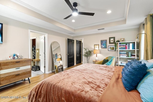 190 Colorado Springs Way, Saint Augustine, FL 32092 - bedroom with a raised ceiling, light wood finished floors, arched walkways, crown molding, and recessed lighting