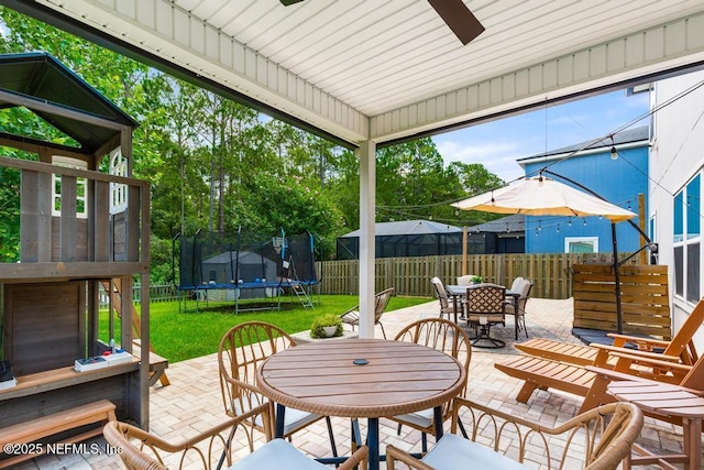 190 Colorado Springs Way, Saint Augustine, FL 32092 - fenced backyard with outdoor dining space, a trampoline, a patio, and a ceiling fan