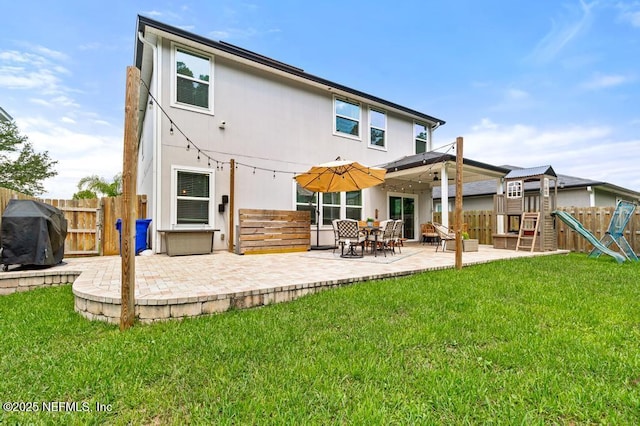 190 Colorado Springs Way, Saint Augustine, FL 32092 - rear view of house featuring a patio area, a fenced backyard, and a playground