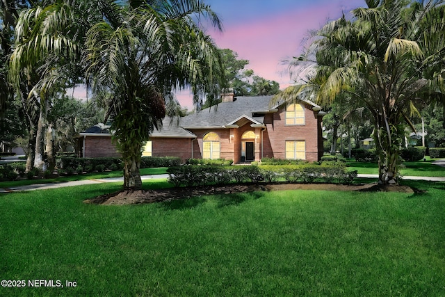 101 Royal Lagoon Ct, Ponte Vedra Beach, FL 32082 - view of front facade featuring brick siding, a yard, a chimney, and a shingled roof