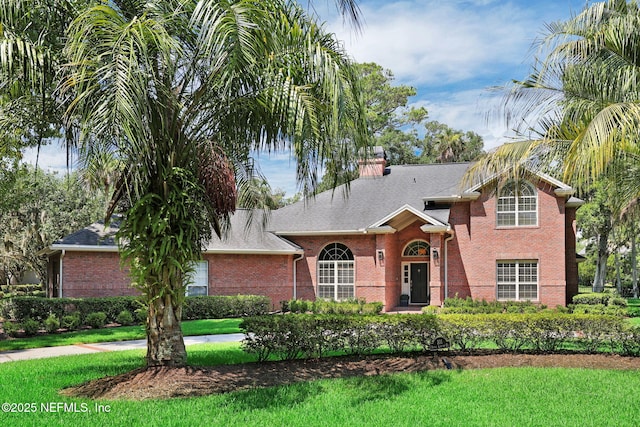 101 Royal Lagoon Ct, Ponte Vedra Beach, FL 32082 - view of front of property featuring brick siding, a front lawn, and a chimney