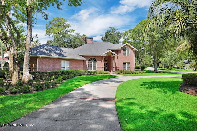 101 Royal Lagoon Ct, Ponte Vedra Beach, FL 32082 - view of front facade with brick siding, a front lawn, and a chimney