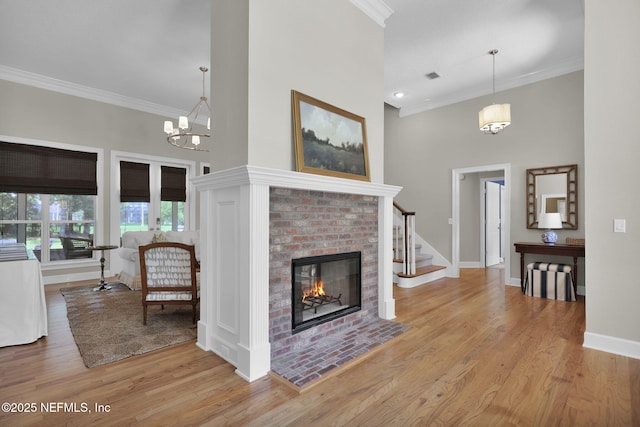 101 Royal Lagoon Ct, Ponte Vedra Beach, FL 32082 - living area with ornamental molding, a high ceiling, a brick fireplace, wood finished floors, and stairway