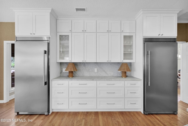 101 Royal Lagoon Ct, Ponte Vedra Beach, FL 32082 - kitchen featuring high end fridge, stainless steel built in fridge, white cabinets, and light wood-style flooring