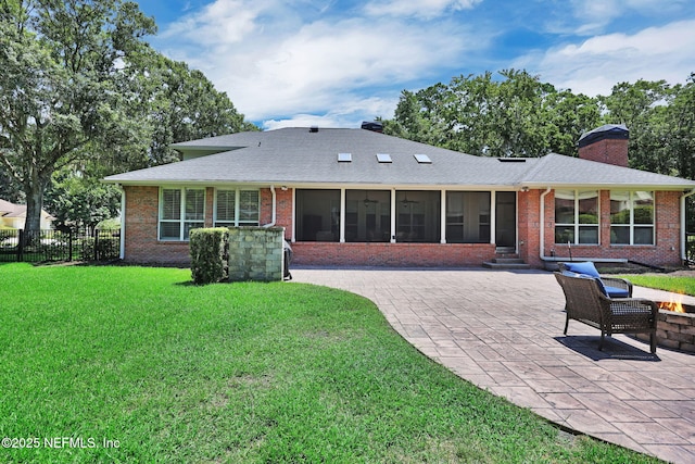 101 Royal Lagoon Ct, Ponte Vedra Beach, FL 32082 - rear view of house with brick siding, a sunroom, a chimney, a patio area, and an outdoor fire pit