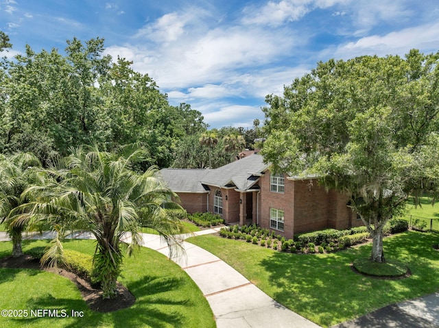 101 Royal Lagoon Ct, Ponte Vedra Beach, FL 32082 - view of front of house with brick siding, a front lawn, and roof with shingles