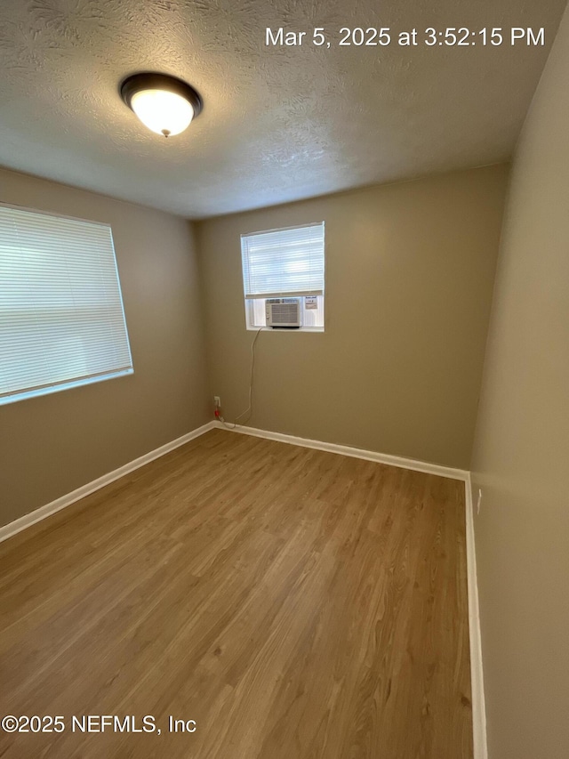 1624 36th St Unit 1-4, Jacksonville, FL 32209 - spare room with cooling unit, wood finished floors, and a textured ceiling
