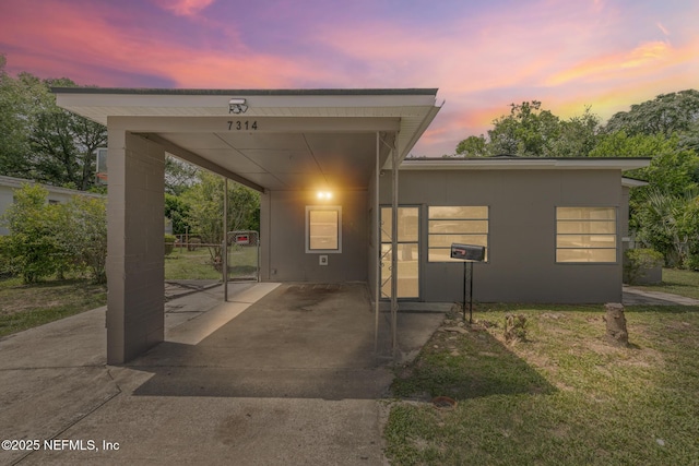 7314 Hielo Dr, Jacksonville, FL 32211 - view of front of home with driveway, an attached carport, and a lawn